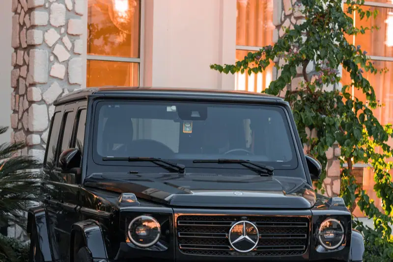 Black Mercedes G-Class parked in front of a building
