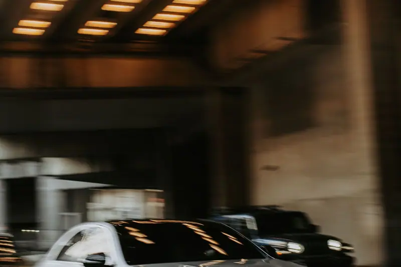 Silver Mercedes sedan driving through a tunnel