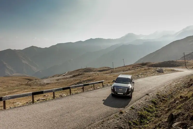 Cadillac SUV on a mountain road