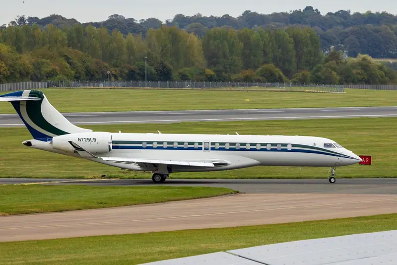 White private jet taxiing on a runway