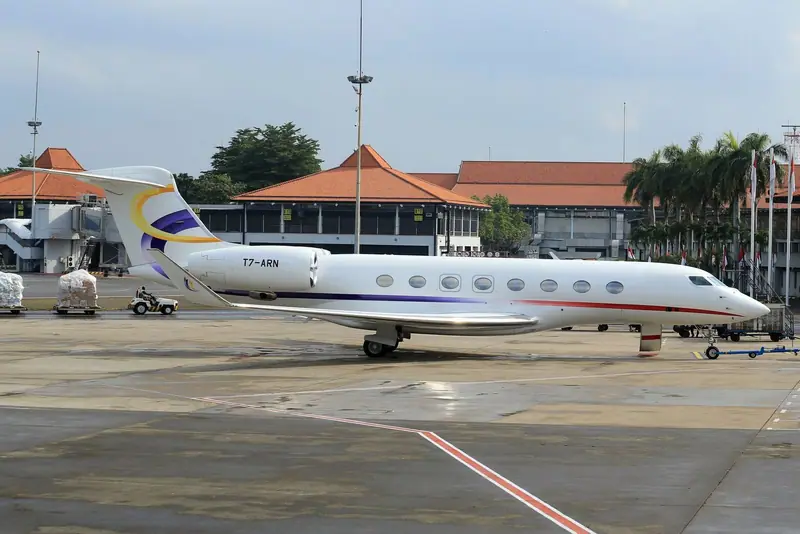 Private jet at an airport with a pagoda-style terminal