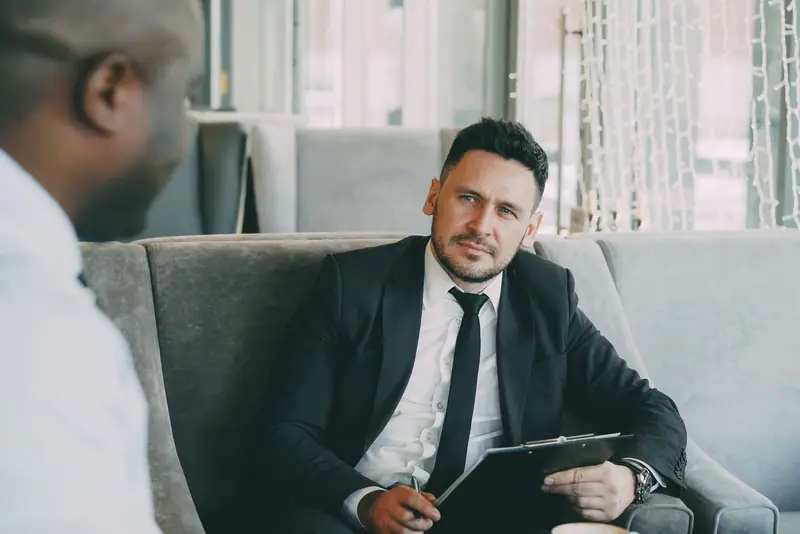 Two businessmen talking in a lounge