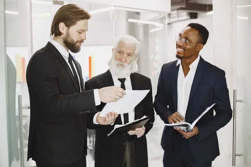 Three businessmen reviewing papers together