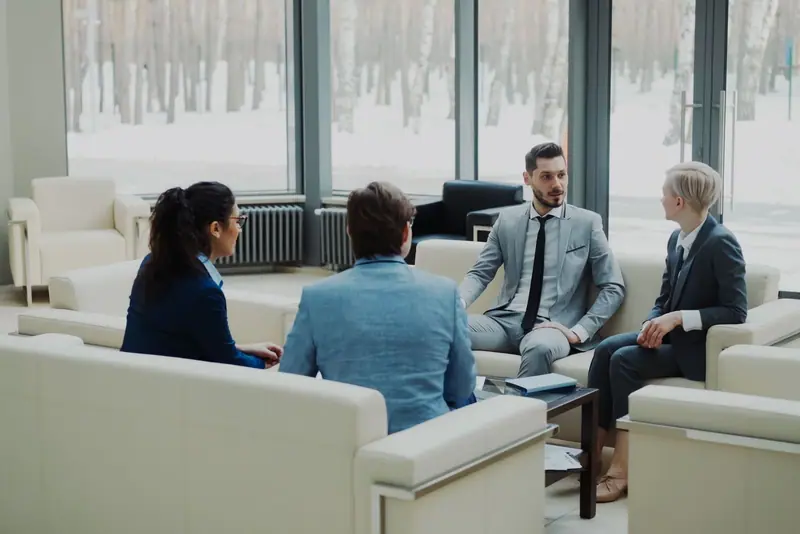 Colleagues talking in a bright lounge
