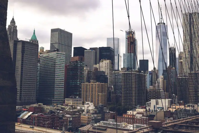Lower Manhattan skyline seen through bridge cables