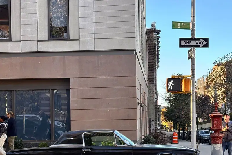 Black classic car at a New York intersection