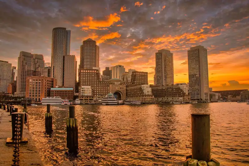 Boston skyline at sunset reflected in the harbour