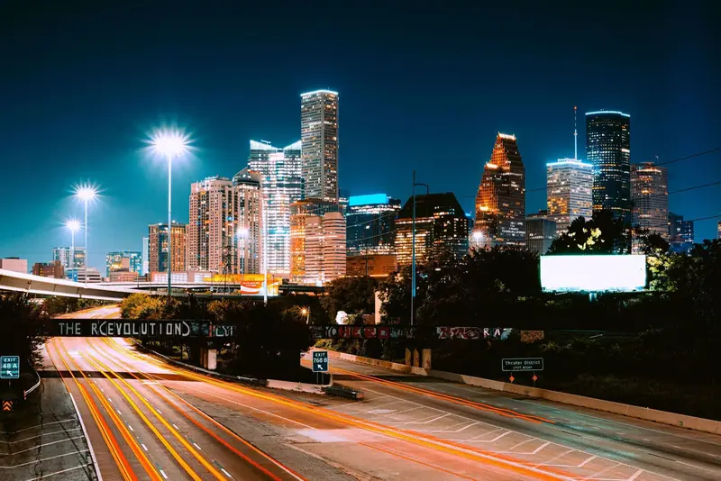 Houston skyline at night above a highway