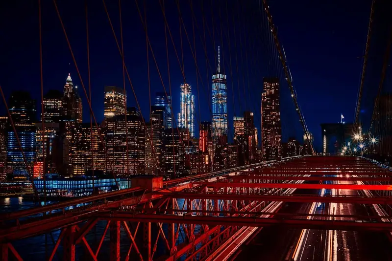 New York skyline at night seen from the Brooklyn Bridge