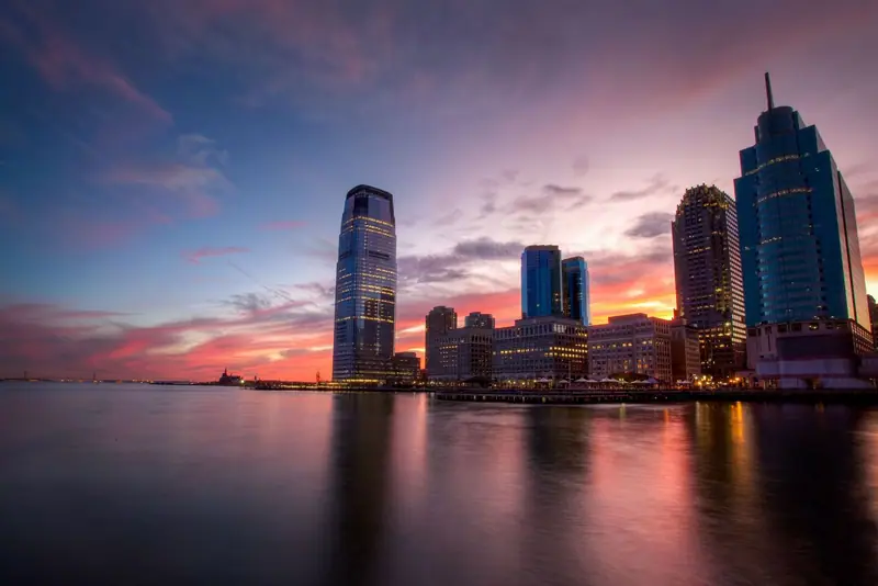 Jersey City waterfront towers at dusk reflected in the water