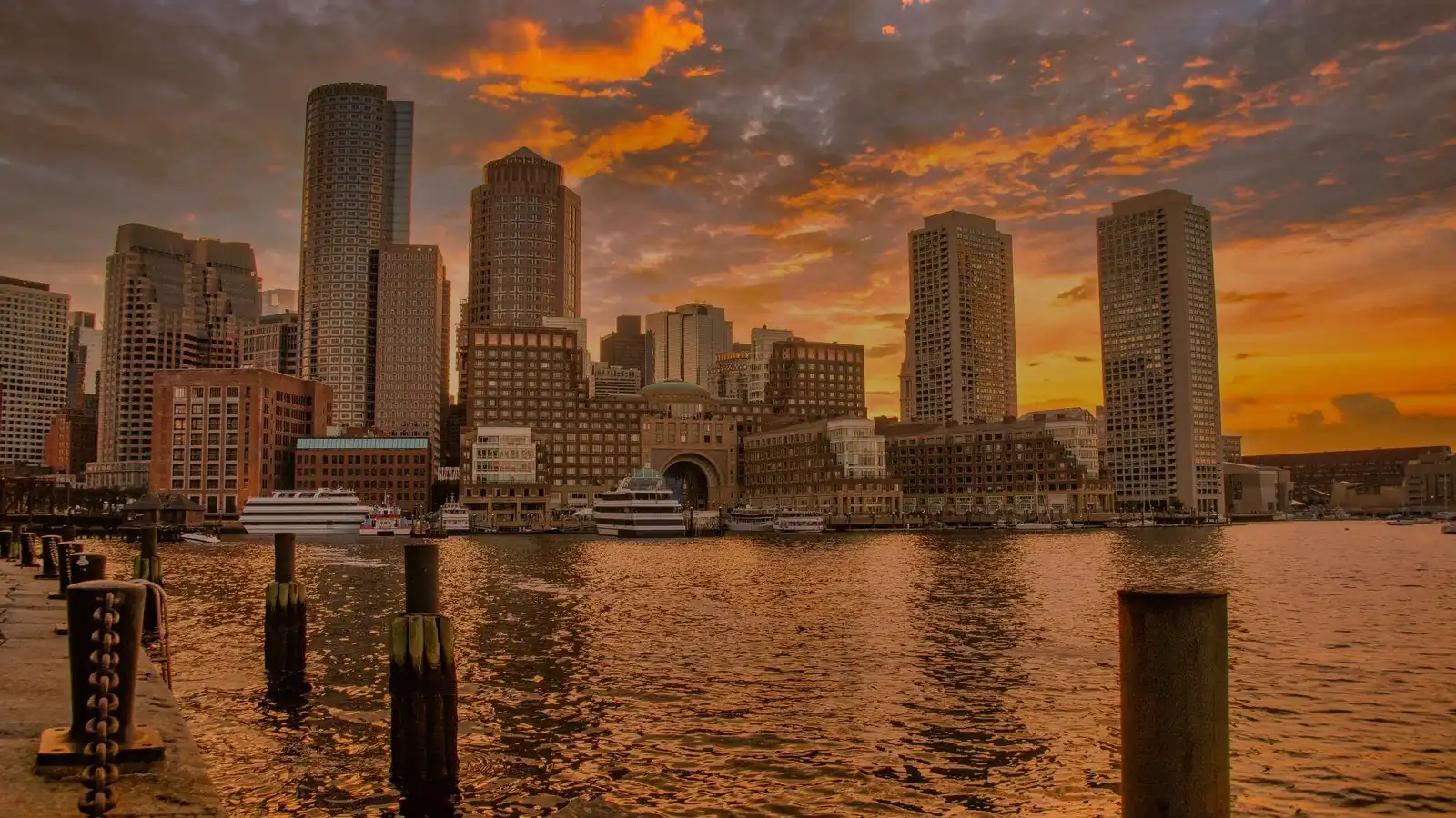 Boston skyline at sunset reflected in the harbour