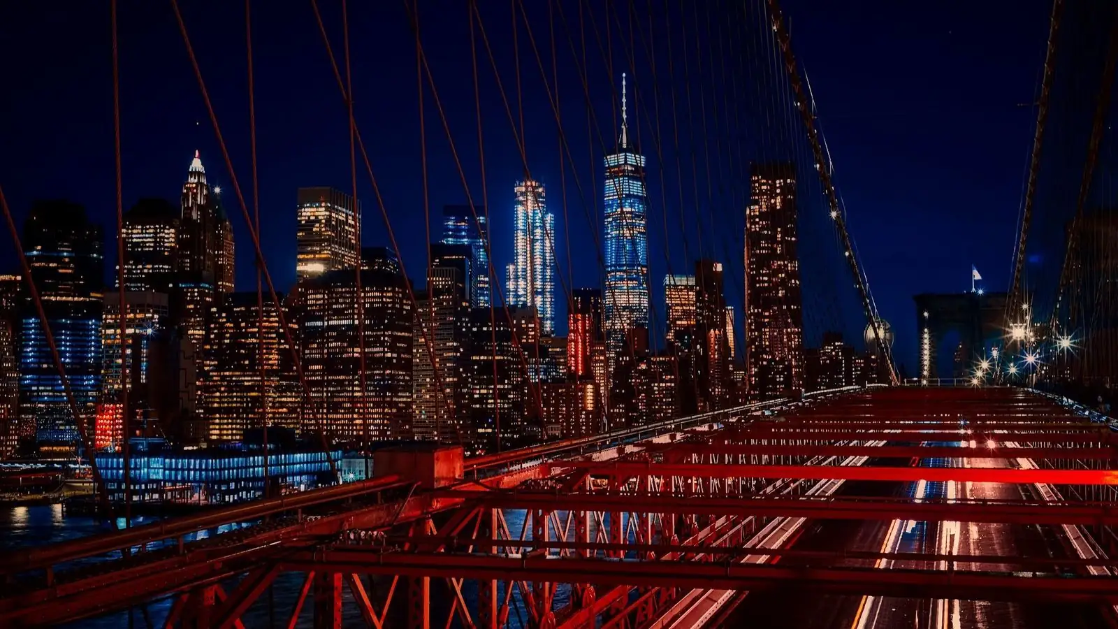 New York skyline at night seen from the Brooklyn Bridge