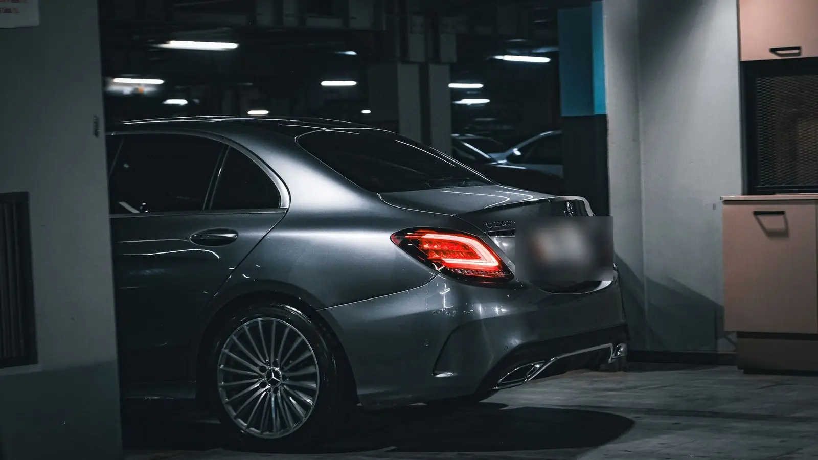Dark grey Mercedes-Benz C-Class parked in an underground car park